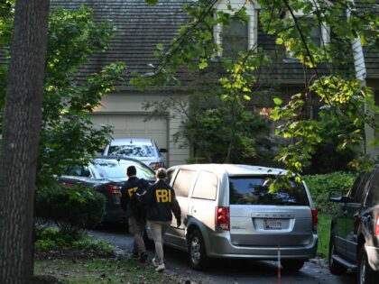 FBI agents walk outside John Bolton's house, Donald Trump's former national security advis