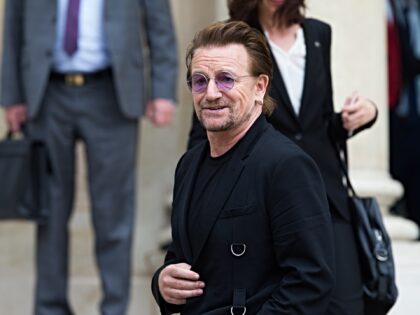 PARIS, FRANCE - JULY 24: Bono (C), singer of U2 and cofounder of the NGO One, arrives to m