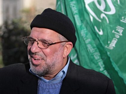 Sheikh Hassan Yousef (L), a prominent leader of the Hamas Islamic movement, flashes the fo