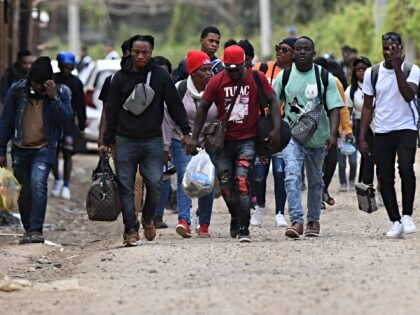 Cuban and Haitian migrants en route to the United States leave the Migrant Care Center aft