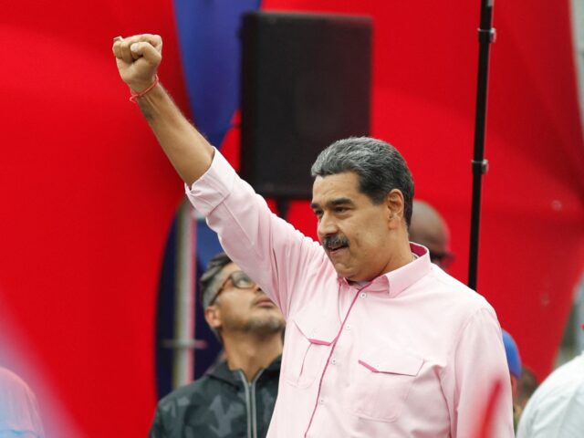 Venezuela's President Nicolas Maduro greets supporters during a march to commemorate May D