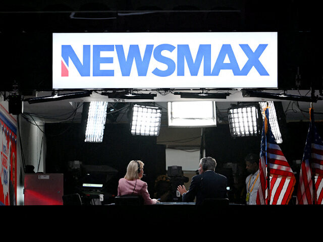 news-anchors-cover-2024-election-newsmax-file-getty News anchors work at Newsmax's booth during the second day of the 2024 Republican National