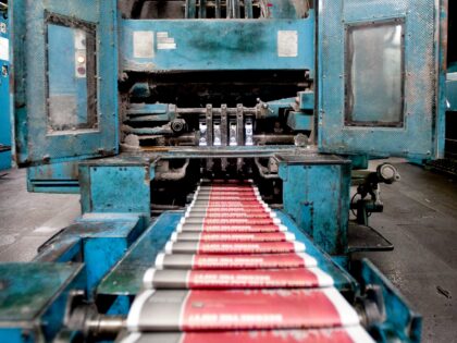 Newspapers are fed through the Dallas Morning News printing press in Plano, Texas, US, Thu