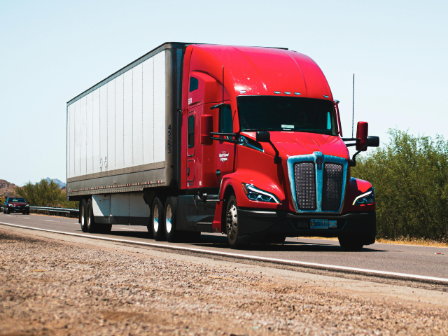 Kenworth T680 Semi-Trailer Truck Driving Down the Road