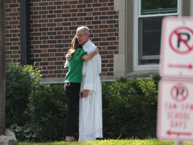 school shooting Members of the church comfort one another after shooting at Annunciation Church on Wednesd