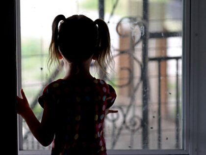 n this Thursday, June 6, 2019, photo, Victory looks out the front door as she plays at hom