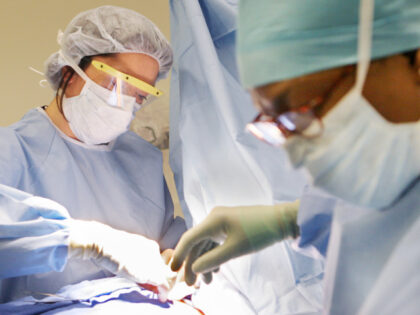 Surgical Technician Ruby Sampson, right, assists as Dr. Monica Bertagnolli, left, performs