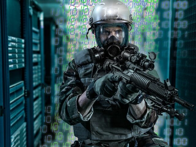 Soldier holding gun in server room