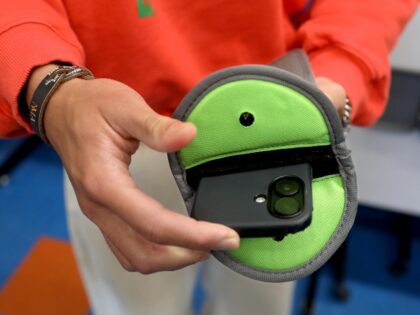 student using a smartphone restriction pouch