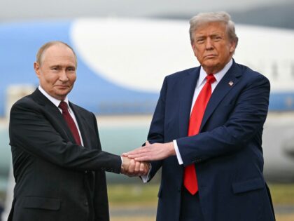 US President Donald Trump greets Russian President Vladimir Putin on the tarmac after they