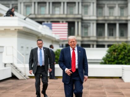 President Donald Trump speaks with Director of Facilities Todd Robinson, architect James M