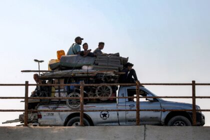Displaced Gazans head south along a coastal road as the Israeli military gears up for a ma