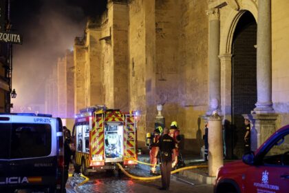 Firefighters work to extinguish a fire in the historic mosque-turned-cathedral in the sout
