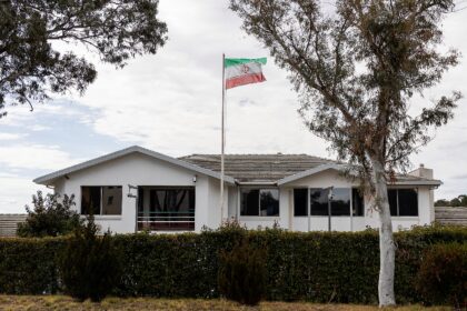 The Iranian national flag flies over the country's embassy building in Canberra on Tu