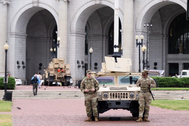 Members of the National Guard stand watch outside of Union Station in the US capital Washi