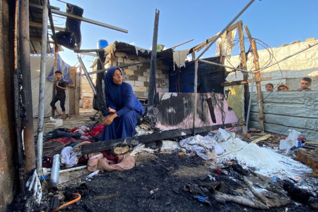 A Palestinian woman at the site of Israeli bombardment on the Al-Mawasi area in the southe