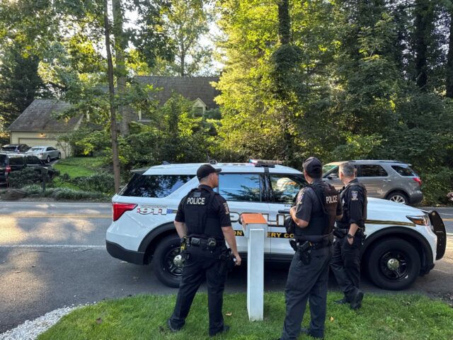 Police officers stand outside the house of John Bolton, President Donald Trump's form