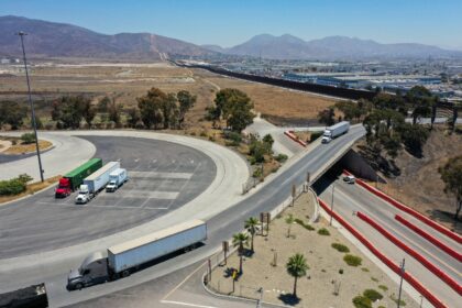 Trucks drive into a California Highway Patrol inspection station after entering from Mexic