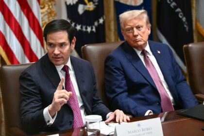 US President Donald Trump looks on as US Secretary of State Marco Rubio speaks during a ca
