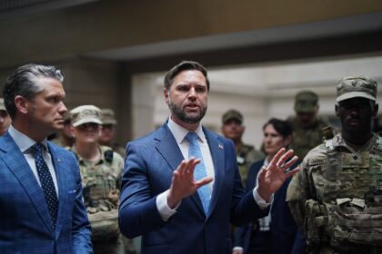 US Vice President JD Vance (C) and Secretary of Defense Pete Hegseth (L) meet with members