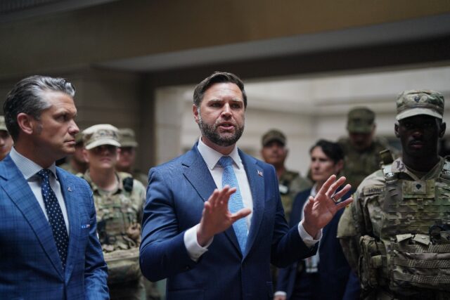 US Vice President JD Vance (C) and Secretary of Defense Pete Hegseth (L) meet with members