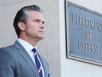 ARLINGTON, VIRGINIA - SEPTEMBER 22: U.S. Secretary of War Pete Hegseth stands at attention