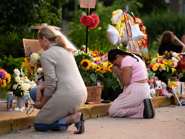 Title: School Shooting Minneapolis Image ID: 25241032325288 Article: People pray at a memorial at Annunciation Catholic Church after Wednesday's school shooting, Thursday, Aug. 28, 2025, in Minneapolis. (AP Photo/Abbie Parr)