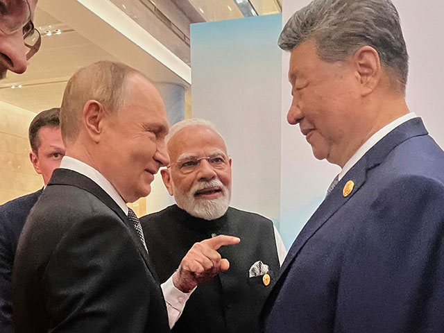 Russian President Vladimir Putin, from left, Indian Prime Minister Narendra Modi and Chinese President Xi Jinping talk ahead of the Shanghai Cooperation Organization (SCO) summit at the Meijiang Convention and Exhibition Center in Tianjin, China, Monday, Sept. 1, 2025. (Indian Prime Minister's Office via AP)