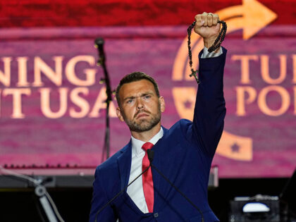 Title: Charlie Kirk Memorial Image ID: 25264712189996 Article: Jack Posobiec holds up a ro