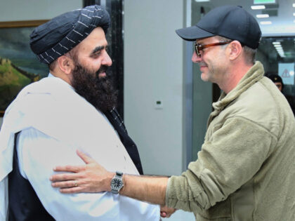 In this photo released by the Taliban Foreign Ministry Press Service, Amir Khan Muttaqi, l