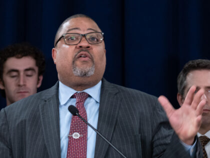 Manhattan District Attorney Alvin Bragg stands with members of his staff at a news confere