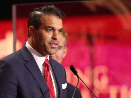 Andrew Kolvet, producer of The Charlie Kirk Show, speaks during the public memorial servic