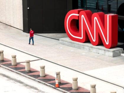 People walk by the world headquarters for CNN on March 15, 2022 in Atlanta, Georgia. Last