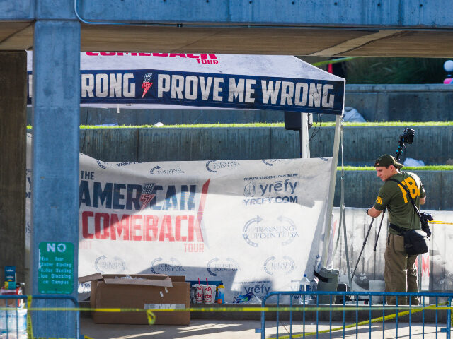 FBI agents walk through the courtyard at Utah Valley University as authorities search for
