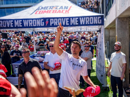 Charlie Kirk throws hats to the crowd after arriving at Utah Valley University on Septembe