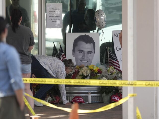 Well-wishers pay their respects at a makeshift memorial at the national headquarters of Tu