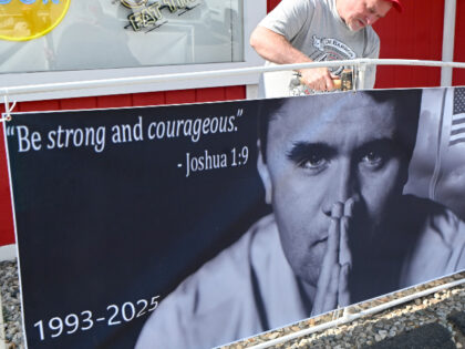 James Meyer of Meriden puts together a poster outside the venue prior to a vigil for Charl