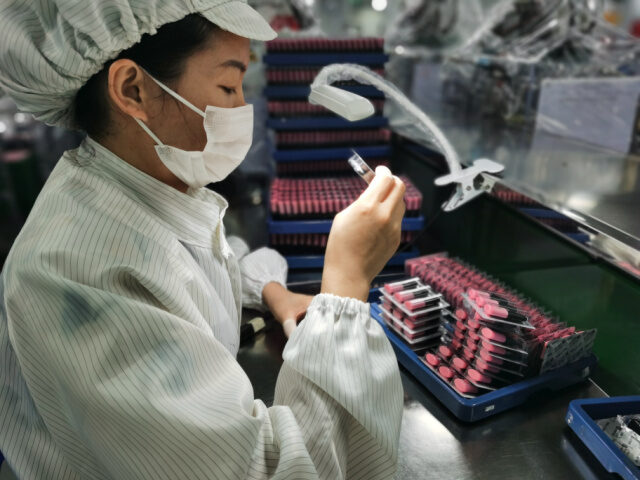 SHENZHEN, CHINA - SEPTEMBER 23: An employee works at RELX e-cigarette factory of Shenzhen