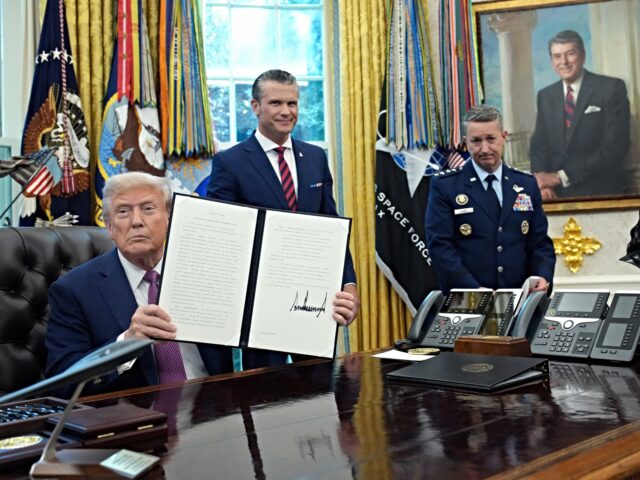 Department of War WASHINGTON, DC - SEPTEMBER 05: U.S. President Donald Trump displays a signed executive ord