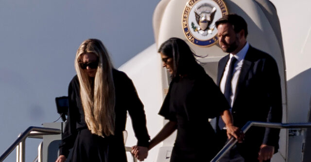 Grieving Erika Kirk Holds Up Cross Necklace to Mourning Supporters