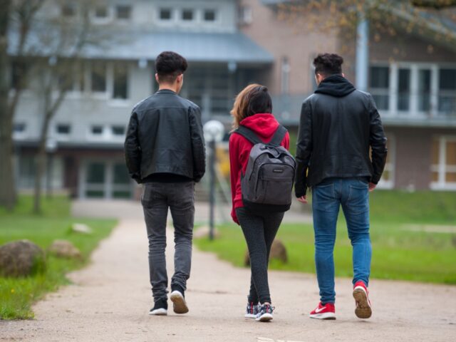 Three adolescent Syrian refugees head to class on the grounds of the Marienau boarding sch