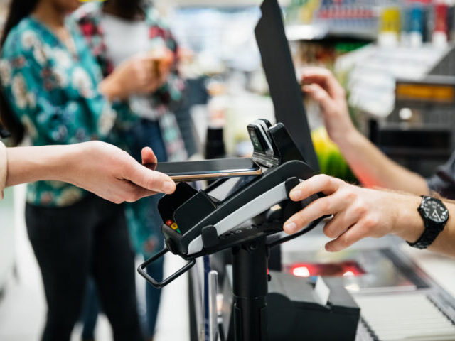 Close Up Of Contactless Payment With Smartphone A close up of a contactless payment being made using a smartphone at the supermarket.