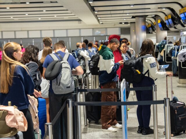 LONDON, ENGLAND - MAY 26: People queue to check in at Heathrow Airport on May 26, 2023 in