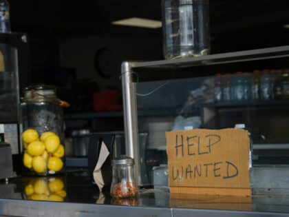 WILDWOOD, NEW JERSEY - MAY 28: A help wanted sign is displayed at a boardwalk restaurant t