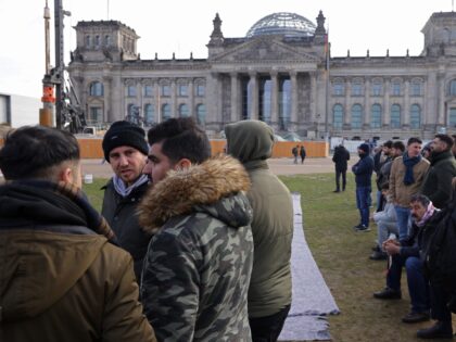 BERLIN, GERMANY - OCTOBER 17: Yazidi men stand outside the Reichstag where colleagues of t