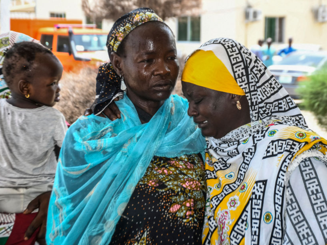 GettyImages-2159372767 Relatives consoles each other as relatives arrive for treatment after a wave of suicide at