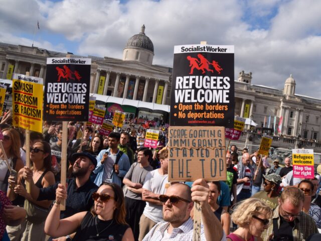 LONDON, UNITED KINGDOM - 2024/08/10: Protesters hold 'Refugees welcome' placards in Trafal