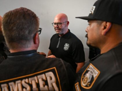 Teamsters General President Sean M. O'Brien shakes hands with workers during a rally