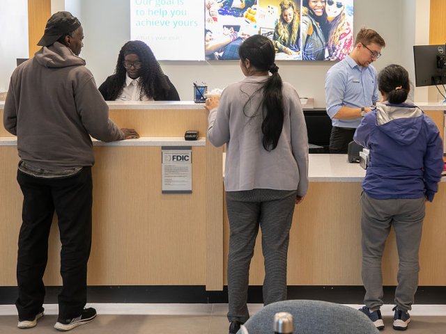 GettyImages-2193927526 BLOOMFIELD, CT - JANUARY 2: TaJan'e Thompson, associate banker, left, and Zach Carey, bran