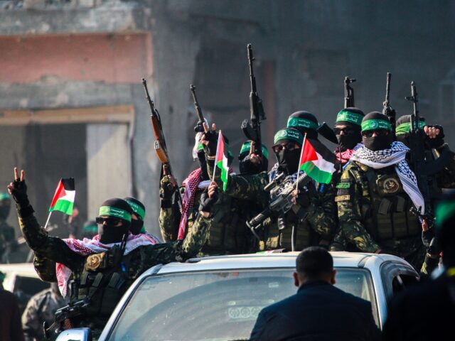 TOPSHOT - Hamas militants arrive in an area before releasing Israeli hostage Agam Berger t